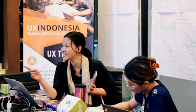 Teacher watching a professional learning session recorded using an AI video creation tool for administrators