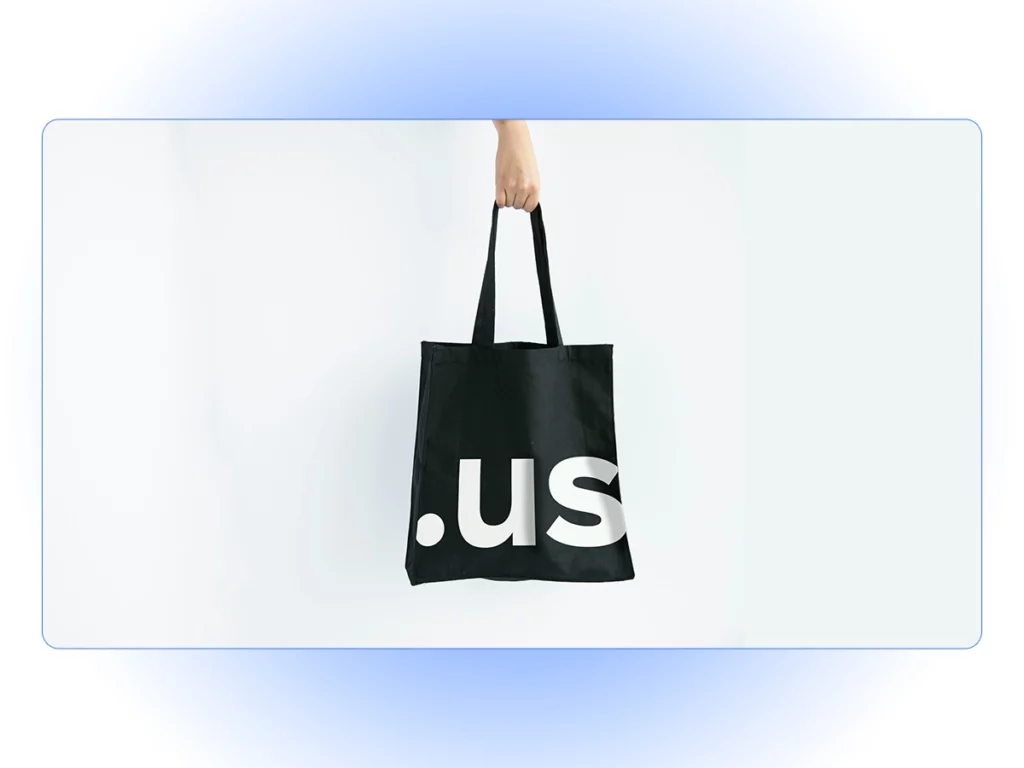 A hand holding a shopping tote bag.